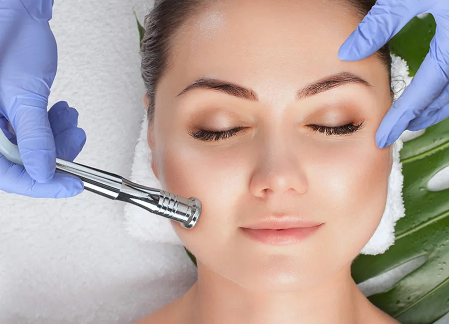 A woman receives a facial treatment