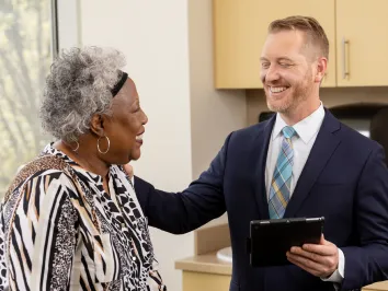 Dr. Hudgens comforting and laughing with a female patient
