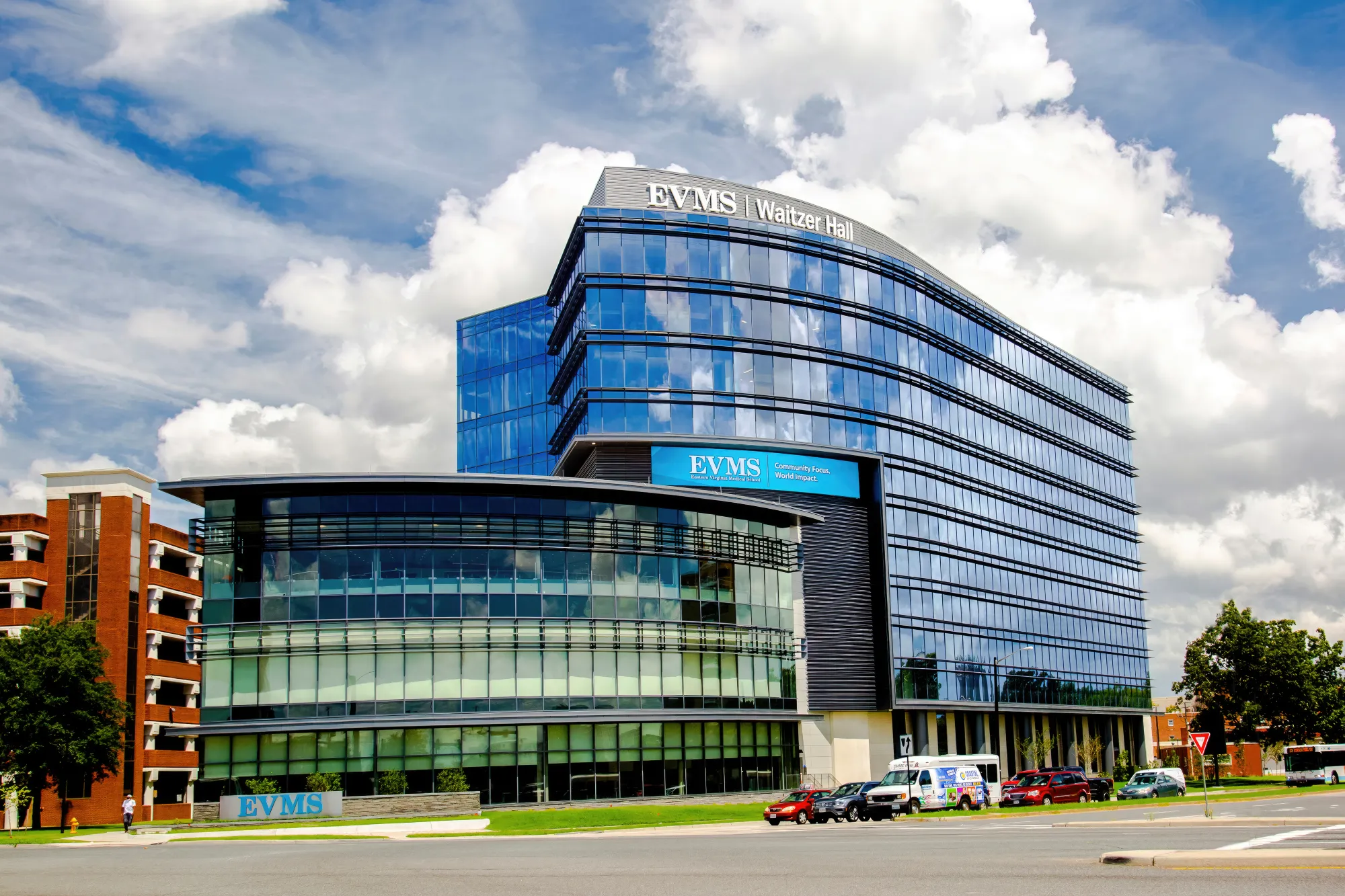 exterior of Waitzer Hall with clouds