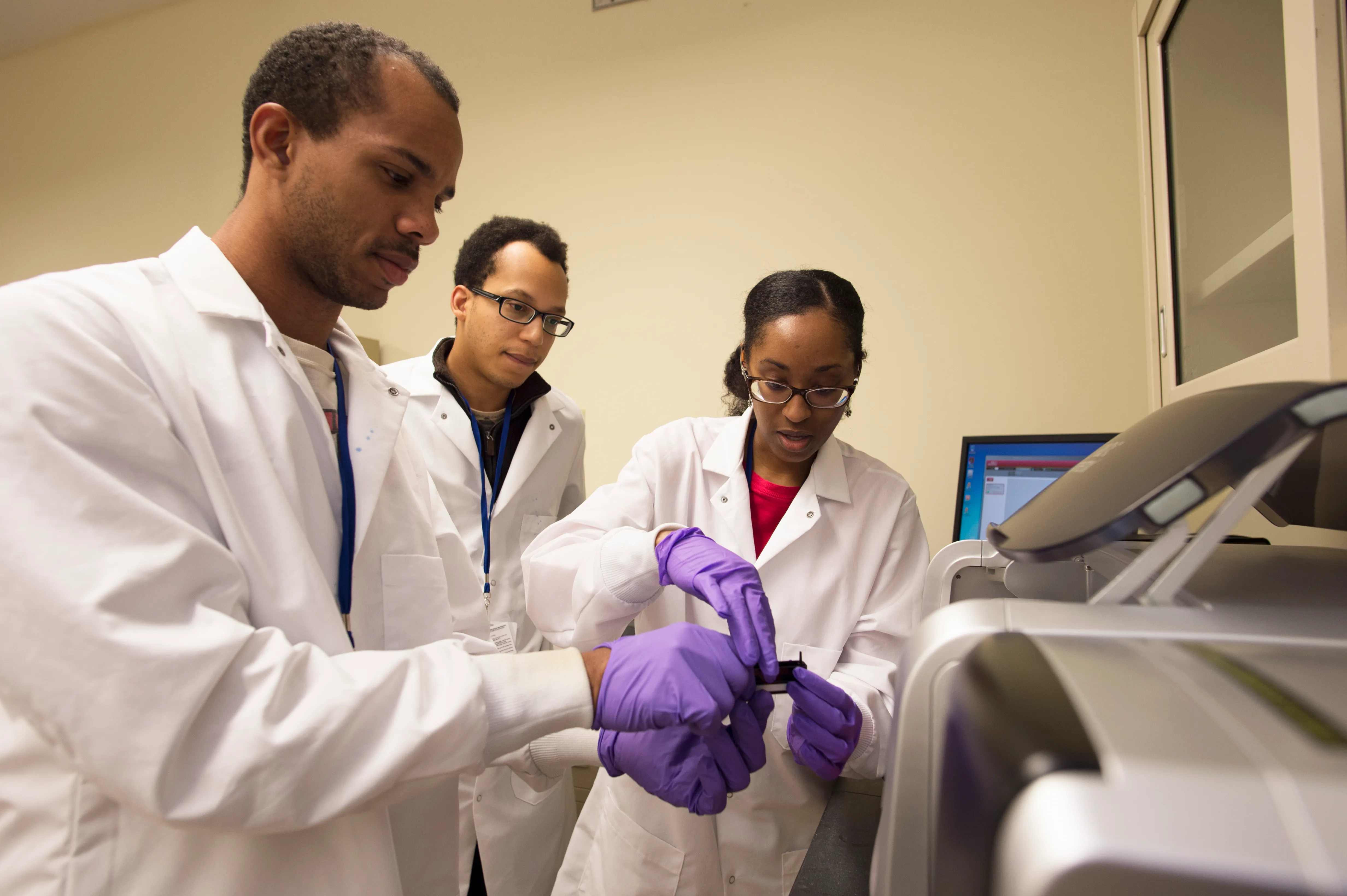 Three students work together in the lab.
