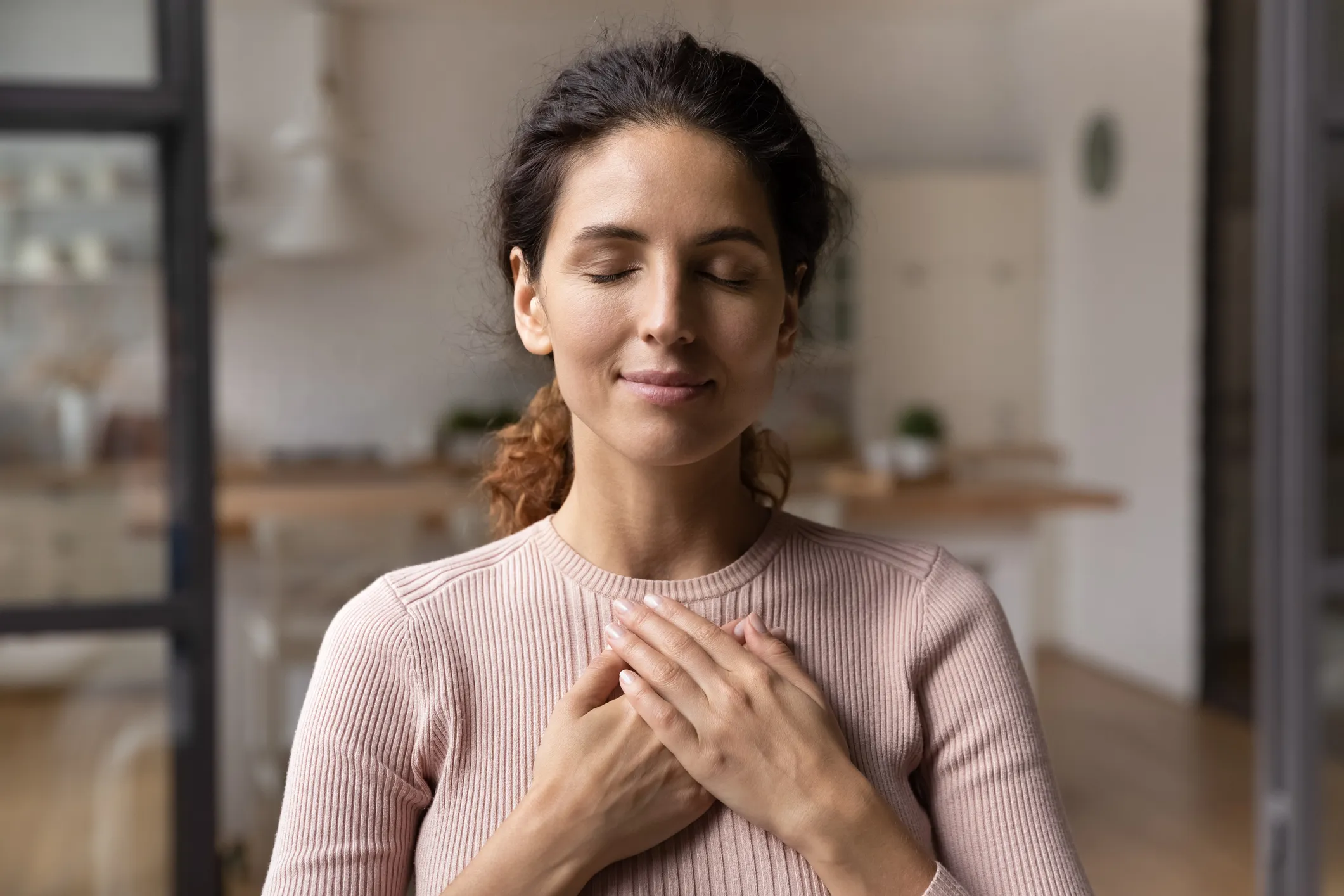 Woman with a hand over her heart