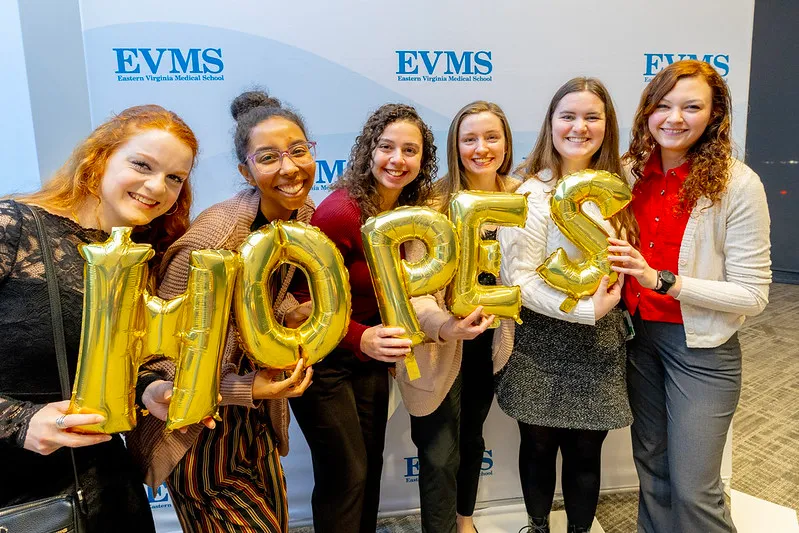 group of student holding balloons that spell HOPES.