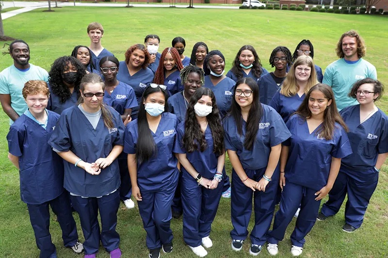 students gathered on lawn in scrubs for HSA.