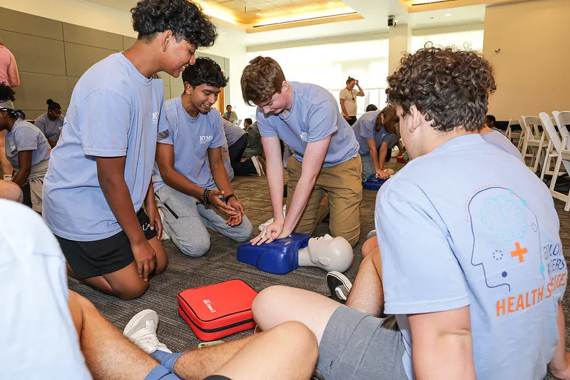 students learning CPR in a classroom.