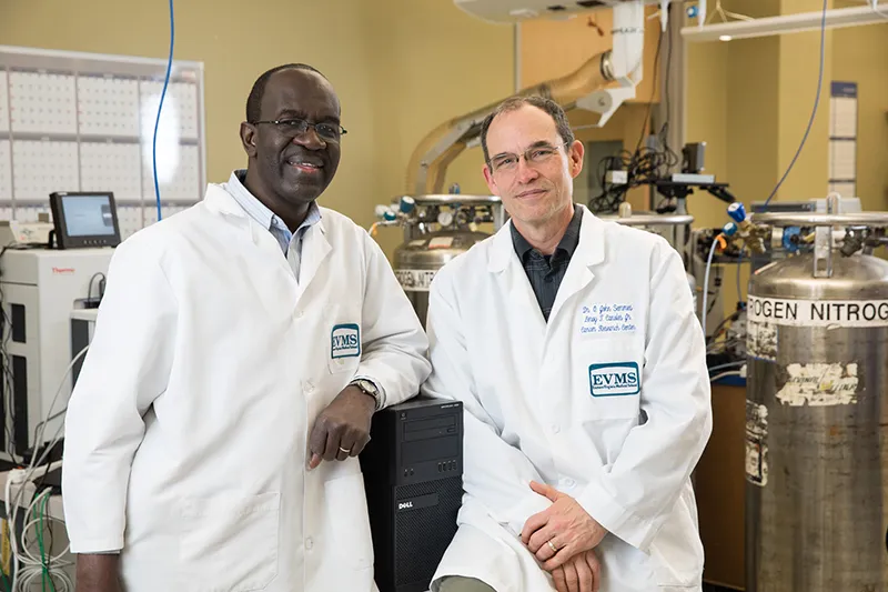 Two researchers sitting next to each other in the lab.