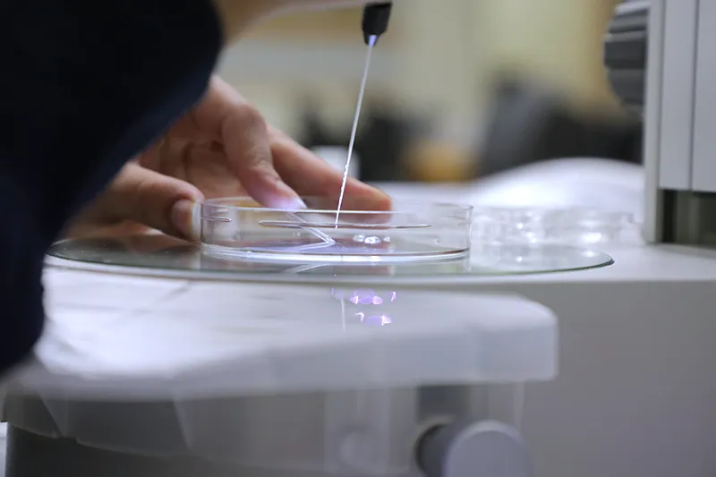 RCS student holds a pipette, close up