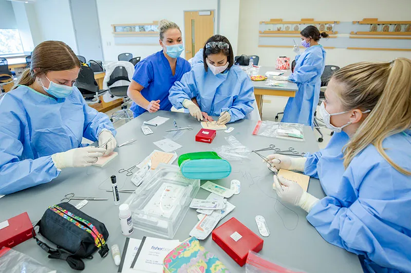 surgical assisting students practice suture skills