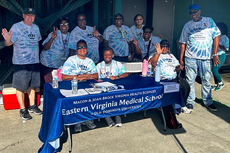 people standing behind a table