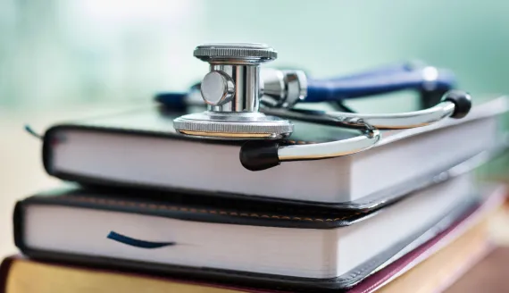 A stack of books with a stethoscope