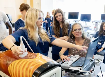 A student performing an ultrasound on a task trainer
