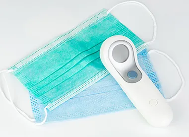two masks and a digital thermometer