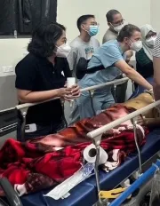 Global Emergency Medicine gather around a patient on a stretcher