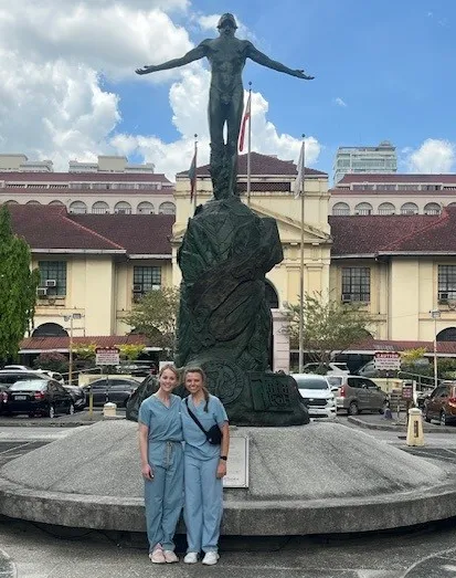 Two fellows in front of naked male stature