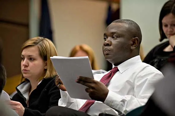 Students take notes during a lecture.