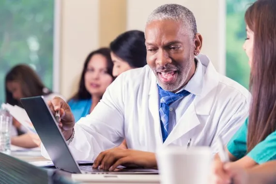 A medical teacher works one-on-one with a student