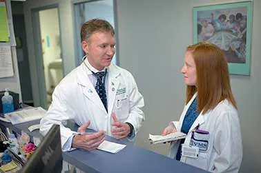 Dr. Ronald Flenner talks with a student.