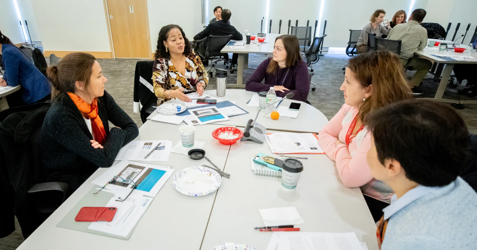 A gathering of faculty members around a table during a workshop