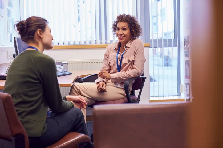 Two colleagues having a discussion in an office