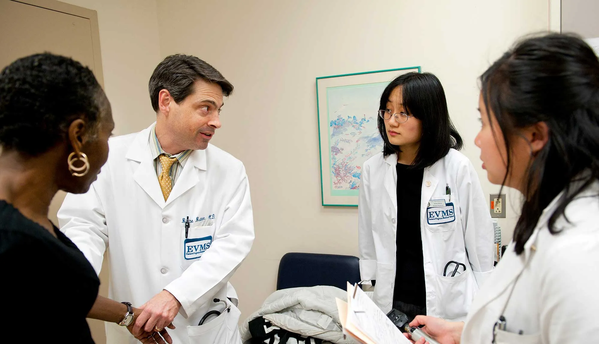 Dr. Bruce Britton demonstrates patient care techniques to students.