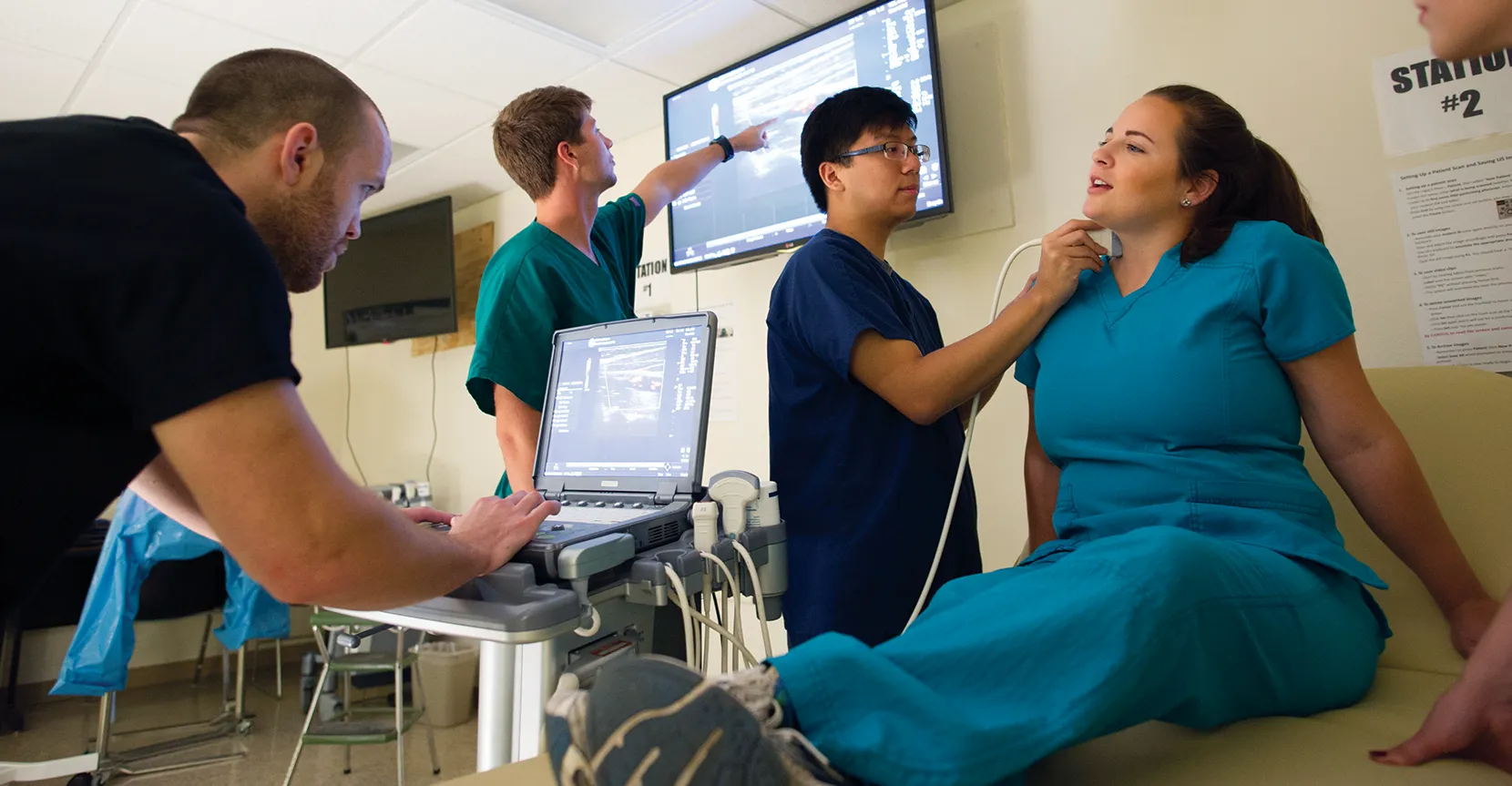 Students practicing one another with a stethoscope