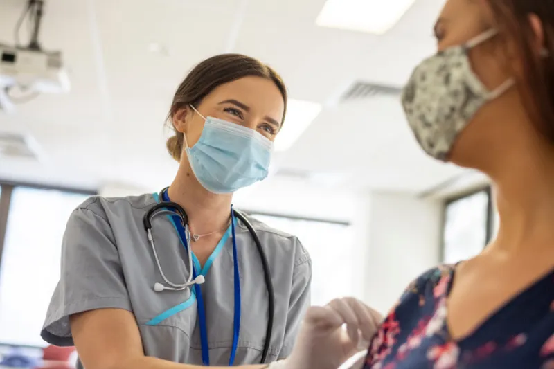 Friendly nurse preps patient prior to vaccine shot
