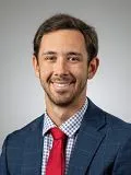 A male doctor posing for a photograph