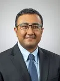 A male doctor posing for a photograph