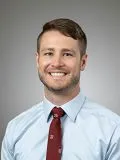 A male doctor posing for a photograph