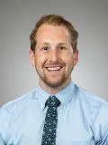 A male doctor posing for a photograph