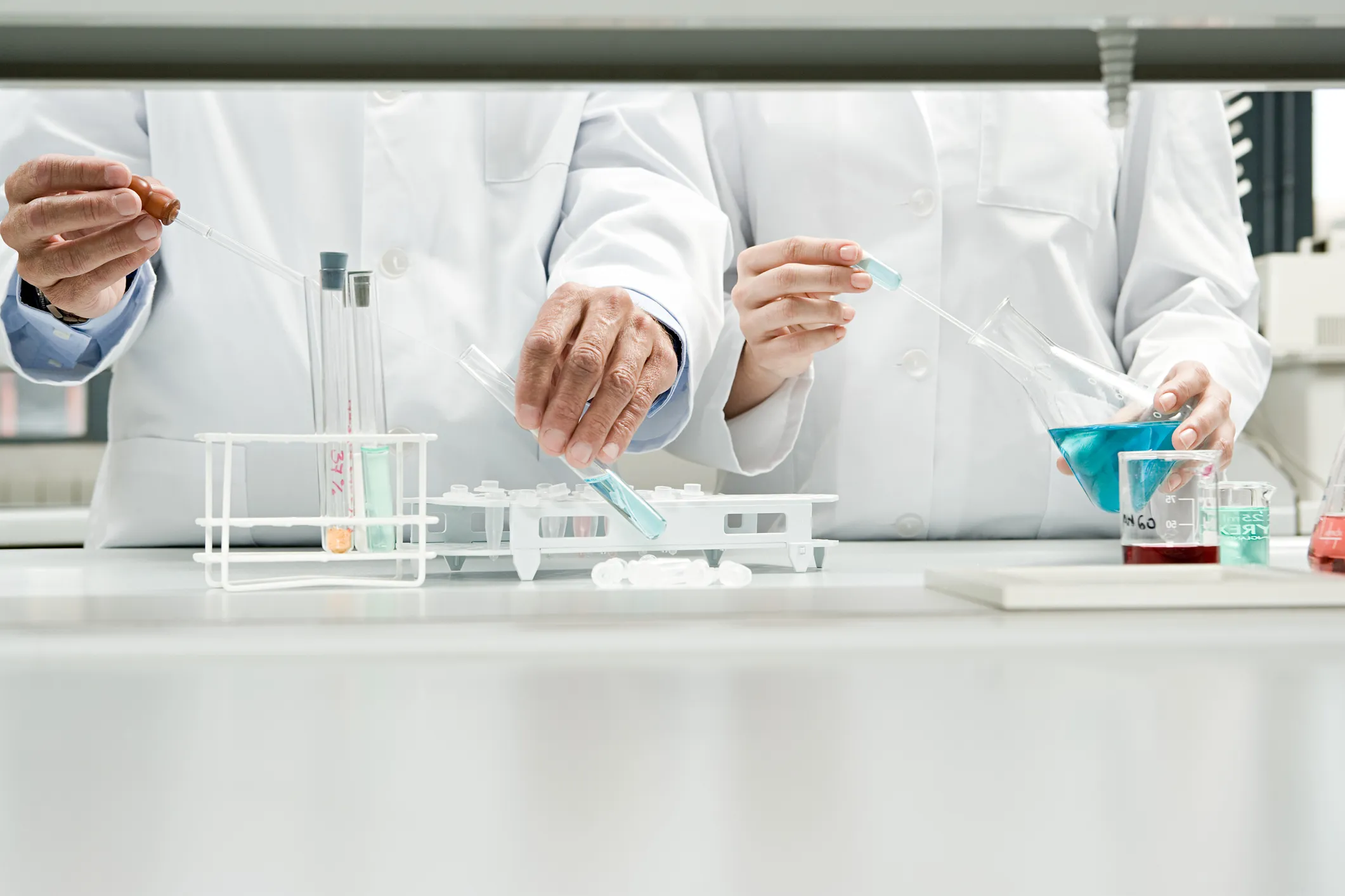 closeups of two pairs of researcher hands working side by side