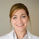 Dr. King is smiling at the camera