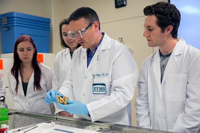 Kerwin Kolheffer, MS shows students organ tissue in a lab.