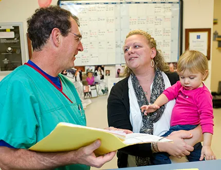 A Clinical Research Unit physician talks with a parent.