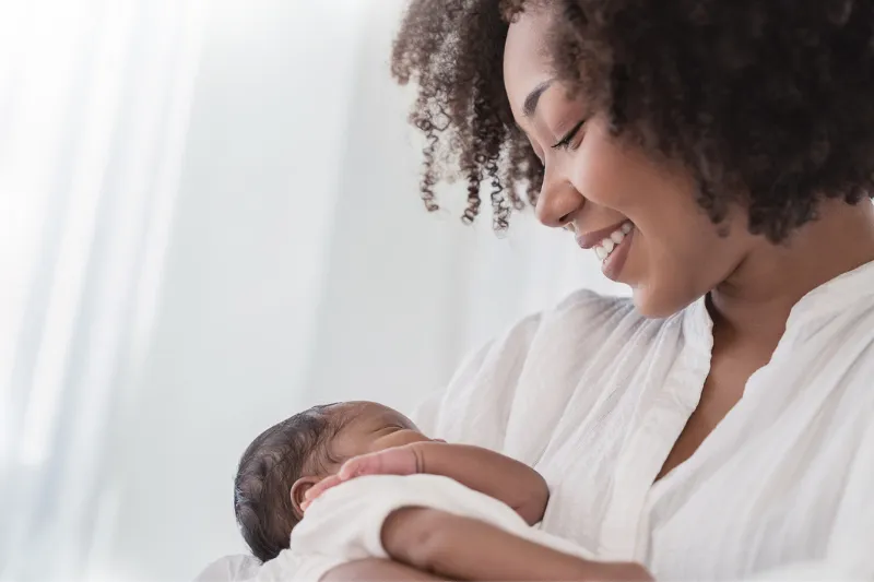 African American woman holding infant
