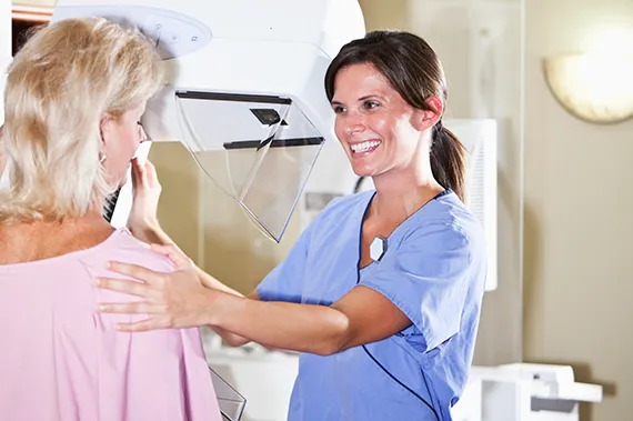 A breast imaging specialist consults with a patient.