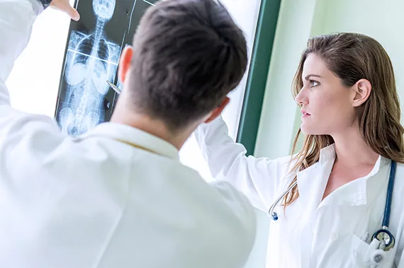 A team of experts inspects an X-ray.