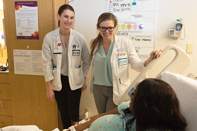 Two students visit a patient in the hospital