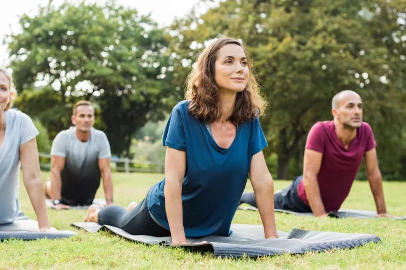 Group of people doing yoga outdoors