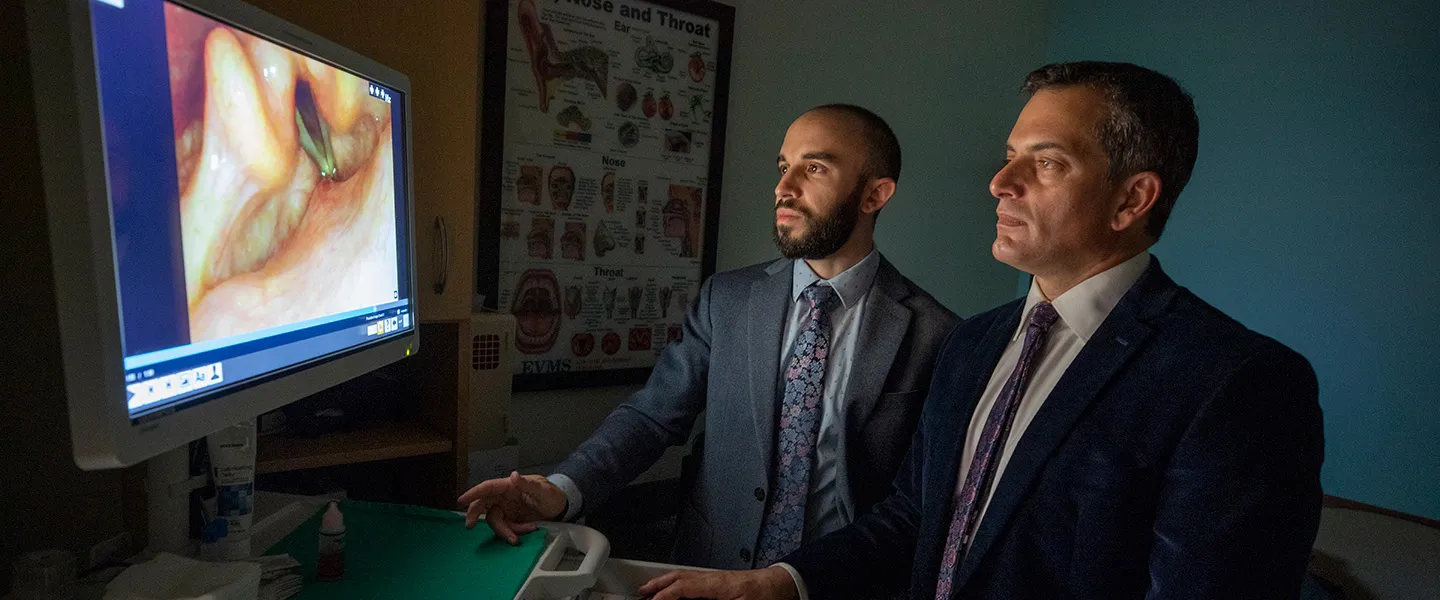 Dr. Rubinstein and Dr. Sinacori examine a video of a laryngosocopy