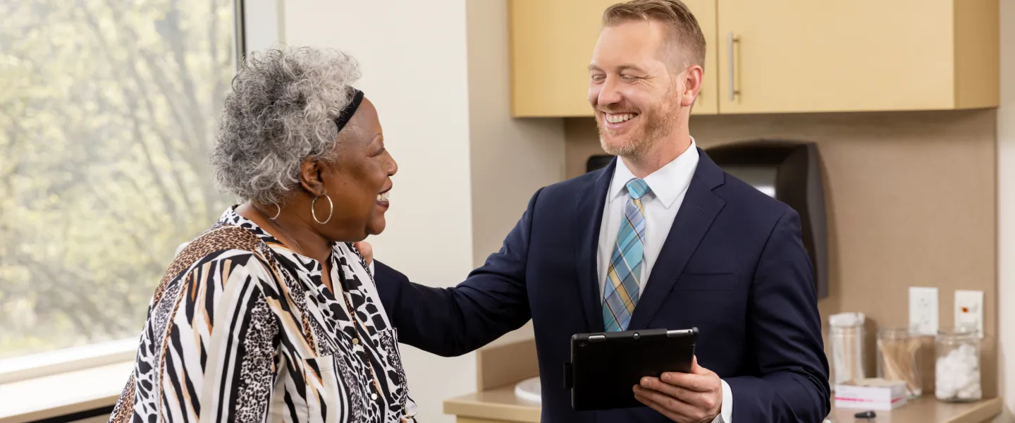 Dr. Hudgens comforting and laughing with a female patient