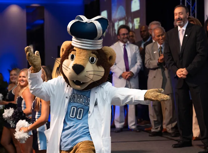 ODU Monarch wearing a white coat