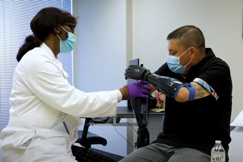 Marcial Sanchez Romero with Dr. Beverly Atwater testing his myoelectric hands