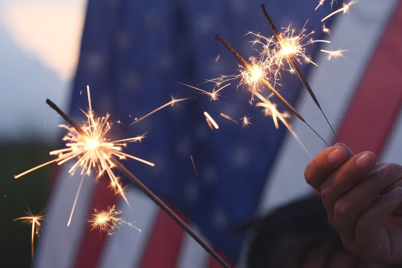 Sparklers in front of an American flag