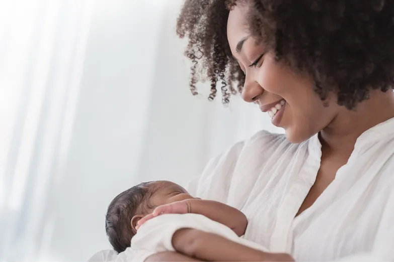 African American woman holding infant